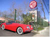 photo of a Jaguar XK120 and our sign